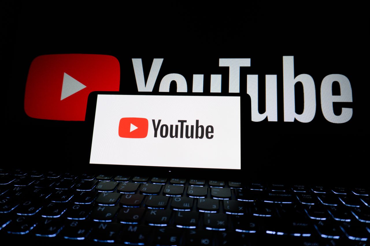 services-03 Close-up of YouTube logo displayed on a laptop screen in a dark environment.